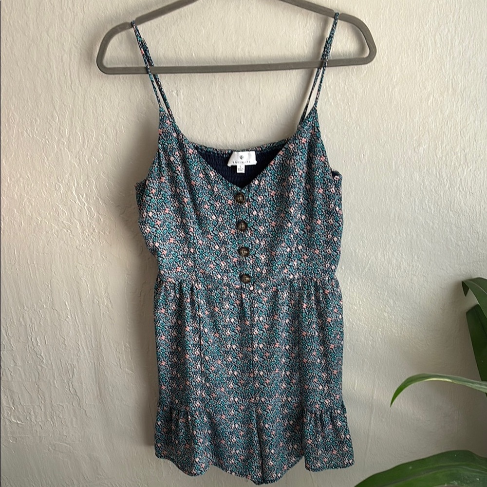 Woman’s blue and pink floral print romper with ruffle detail